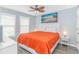 Bright bedroom features a ceiling fan, painting, and windows with blinds at 6001- 8005 S Kings Hwy., Myrtle Beach, SC 29575