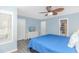 Spacious blue bedroom featuring a ceiling fan, closet, and connecting bathroom at 6001- 8005 S Kings Hwy., Myrtle Beach, SC 29575