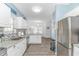 Bright and airy kitchen with white cabinetry, stainless steel appliances, granite countertops, and a stylish backsplash at 6001- 8005 S Kings Hwy., Myrtle Beach, SC 29575