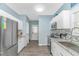 Charming kitchen featuring white cabinets, stainless steel appliances, granite countertops, and mosaic backsplash at 6001- 8005 S Kings Hwy., Myrtle Beach, SC 29575