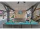 Comfortable outdoor seating area under the stilted home, featuring a cozy sectional and mounted television for entertainment at 6001- 8005 S Kings Hwy., Myrtle Beach, SC 29575