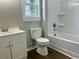 Bathroom features a white vanity, toilet, and tub with white wall surround at 608 Miles Ct, Marion, SC 29571