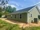 Side view of a light green home with black roof and an AC unit at 608 Miles Ct, Marion, SC 29571