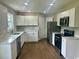 Modern kitchen featuring white cabinets, stainless steel appliances, and marble countertops at 608 Miles Ct, Marion, SC 29571