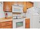 Functional kitchen with oak cabinetry and white appliances at 618 N Waccamaw Dr. # A-5, Murrells Inlet, SC 29576