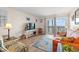 Inviting living room boasts comfortable seating and ocean view access at 618 N Waccamaw Dr. # A-5, Murrells Inlet, SC 29576