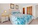 Comfortable main bedroom featuring beach-themed decor, closet, and bedside table at 618 N Waccamaw Dr. # A-5, Murrells Inlet, SC 29576