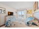 Comfortable main bedroom featuring a TV, balcony access, and beach-themed decor at 618 N Waccamaw Dr. # A-5, Murrells Inlet, SC 29576
