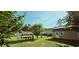 Backyard featuring a storage shed with a door, surrounded by a well-maintained lawn and fenced perimeter at 618 Wintercreeper Dr., Longs, SC 29568