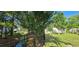 Landscaped backyard with a black metal fence by a stream, enhancing privacy and outdoor enjoyment at 618 Wintercreeper Dr., Longs, SC 29568