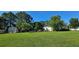 Expansive backyard with well-maintained lawn, fenced perimeter, storage shed, and mature trees for privacy at 618 Wintercreeper Dr., Longs, SC 29568