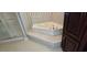 Relaxing bathroom showcasing a large corner tub and a glass-enclosed shower for spa-like comfort at 618 Wintercreeper Dr., Longs, SC 29568