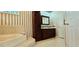 Inviting bathroom with a soaking tub and vanity with dark wood cabinets and a coordinated mirror at 618 Wintercreeper Dr., Longs, SC 29568