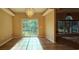 Light-filled dining room with a chandelier and sliding glass doors to the backyard at 618 Wintercreeper Dr., Longs, SC 29568