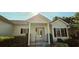 Inviting front entrance with a covered porch and stylish glass door, perfect for welcoming guests at 618 Wintercreeper Dr., Longs, SC 29568