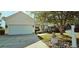 Charming home with a two-car garage, landscaped front yard, and mature trees offering ample shade at 618 Wintercreeper Dr., Longs, SC 29568