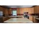 Beautiful kitchen featuring wood cabinets, stainless steel appliances, tile flooring, and a large center island at 618 Wintercreeper Dr., Longs, SC 29568