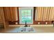 Close up of a kitchen sink surrounded by warm, wood cabinetry, providing ample natural light from the window at 618 Wintercreeper Dr., Longs, SC 29568