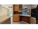 Kitchenette featuring custom cabinetry and sink, seamlessly connecting to adjacent dining and living area at 618 Wintercreeper Dr., Longs, SC 29568