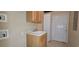 Practical laundry room with a sink, storage cabinet, and direct access to the exterior at 618 Wintercreeper Dr., Longs, SC 29568