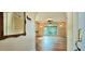 Bright living room featuring hardwood floors, arched entryway, large windows, and elegant lighting fixtures at 618 Wintercreeper Dr., Longs, SC 29568