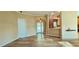Bright living room featuring wood floors, arched doorway, and view to the kitchen at 618 Wintercreeper Dr., Longs, SC 29568