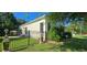 Well-maintained side yard with a black fence, lush green lawn, and mature trees offering privacy at 618 Wintercreeper Dr., Longs, SC 29568