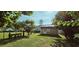 Backyard featuring a storage shed with a door, surrounded by a well-maintained lawn and fenced perimeter at 618 Wintercreeper Dr., Longs, SC 29568