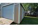 Featuring durable wood siding and a convenient roll-up door, perfect for storing your outdoor essentials at 618 Wintercreeper Dr., Longs, SC 29568