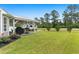 Wide-open backyard featuring a covered patio and parked recreational vehicle at 620 Seth Ln., Longs, SC 29568