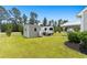 A wide view of the backyard that includes a shed, RV, and outdoor entertainment space at 620 Seth Ln., Longs, SC 29568