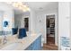 Bathroom featuring double sinks, blue cabinets, a walk-in closet and natural light at 620 Seth Ln., Longs, SC 29568