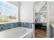 Well-lit bathroom with a tub, tiled backsplash, and a view into the bedroom at 620 Seth Ln., Longs, SC 29568