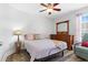 This bedroom has a ceiling fan and a wooden dresser with a large mirror at 620 Seth Ln., Longs, SC 29568