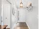 Bright foyer with wood floors and decorative details, including a coat rack and pendant lighting at 620 Seth Ln., Longs, SC 29568