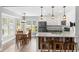 Bright kitchen and dining area featuring a central island, stainless steel appliances, and large windows at 620 Seth Ln., Longs, SC 29568