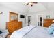 Bedroom with a ceiling fan, mirror and TV, leading to a bathroom and closet at 620 Seth Ln., Longs, SC 29568
