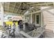 Covered patio with a ceiling fan is complete with outdoor seating and a barbecue grill at 620 Seth Ln., Longs, SC 29568