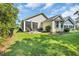 Well-manicured backyard featuring a screened porch and patio with outdoor seating at 628 Grand Cypress Way, Murrells Inlet, SC 29576