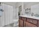 Bright bathroom featuring a tub-shower combo with white shower curtain and modern vanity at 628 Grand Cypress Way, Murrells Inlet, SC 29576