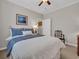 Bright bedroom with white bedding, neutral walls, and dark wood chair at 628 Grand Cypress Way, Murrells Inlet, SC 29576