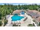 Aerial shot of a community pool with lounge chairs and umbrellas at 628 Grand Cypress Way, Murrells Inlet, SC 29576
