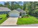 Inviting single-story home with a well-kept lawn and charming front porch at 628 Grand Cypress Way, Murrells Inlet, SC 29576