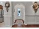 Hallway view with detailed trim and front door with glass insert at 628 Grand Cypress Way, Murrells Inlet, SC 29576