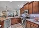 Modern kitchen with stainless steel appliances, granite countertops, and ample cabinet space at 628 Grand Cypress Way, Murrells Inlet, SC 29576