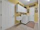Bright laundry room features a utility sink, white cabinetry, washer, and dryer at 628 Grand Cypress Way, Murrells Inlet, SC 29576