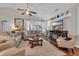 Well-lit living room with ceiling fan, fireplace, and sliding doors to outdoor living at 628 Grand Cypress Way, Murrells Inlet, SC 29576