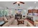 Bright living room featuring a fireplace, plush seating, and an open connection to the kitchen at 628 Grand Cypress Way, Murrells Inlet, SC 29576