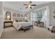 Spacious main bedroom with neutral tones, desk area and large windows with abundant natural light at 628 Grand Cypress Way, Murrells Inlet, SC 29576