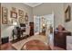 Inviting office featuring hardwood floors, many framed photographs, and a comfortable leather ottoman at 628 Grand Cypress Way, Murrells Inlet, SC 29576